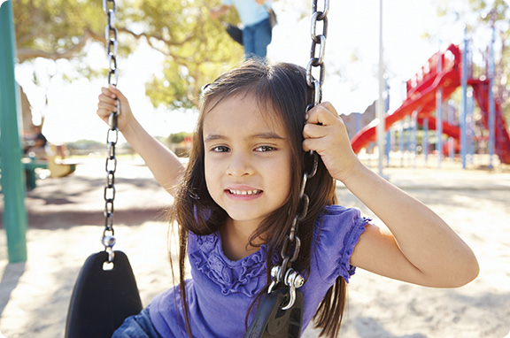 A young girl named Mary sitting on a swing at the YMCA
